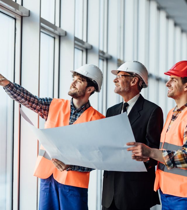 architect man showing something on project to his colleague fore